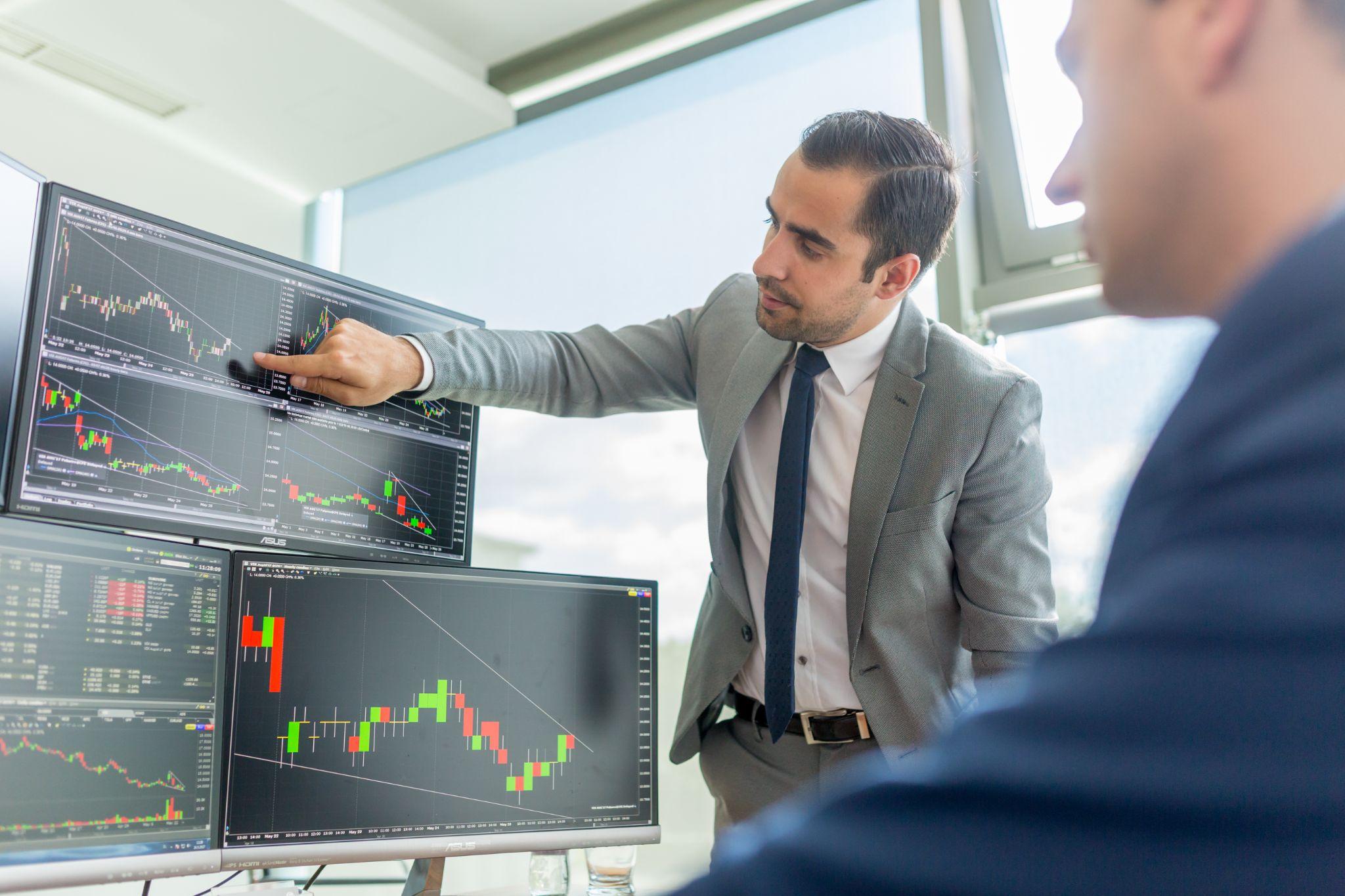 Analyzing diverse algorithmic trading strategies on multiple screens.