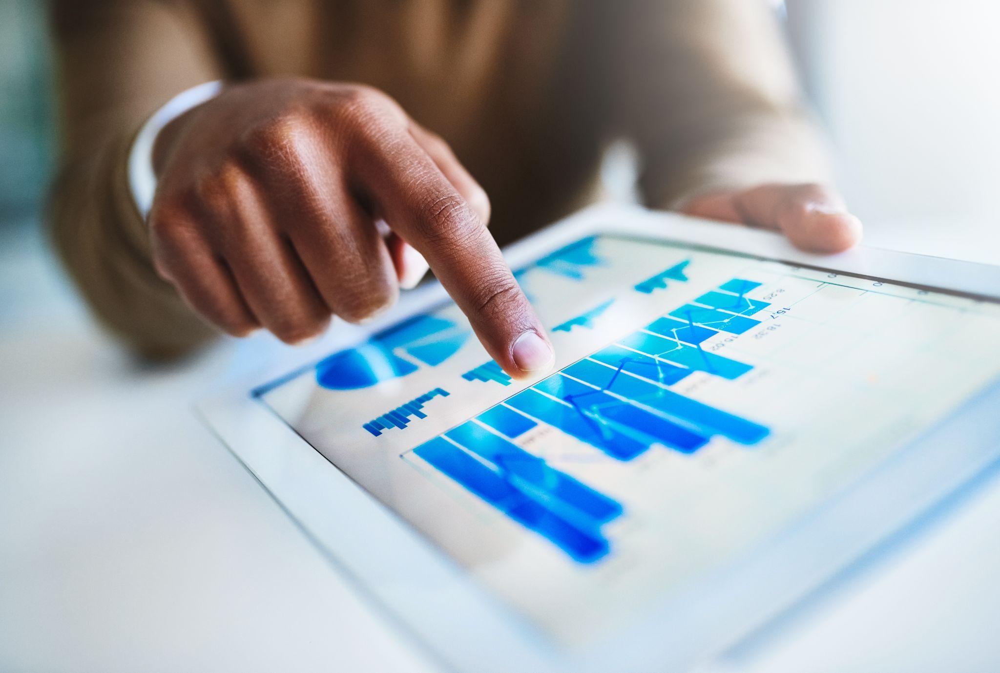 Stock market data on computer screen, team analyzing statistics. Laptop app boosts stats for analyst teamwork in office.